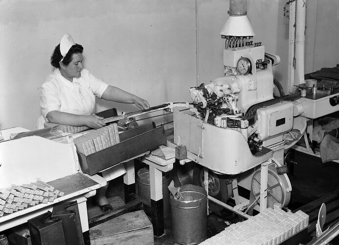 MacRobertson's Pty Ltd, Worker Packaging Confectionery Products in Factory, Fitzroy, Victoria, Oct 1954