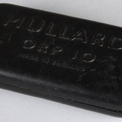 Rectangular dark photocell. Raised lettering on top.