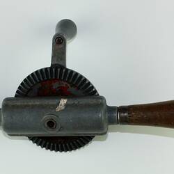 Metal hand turning drill with wood handle.