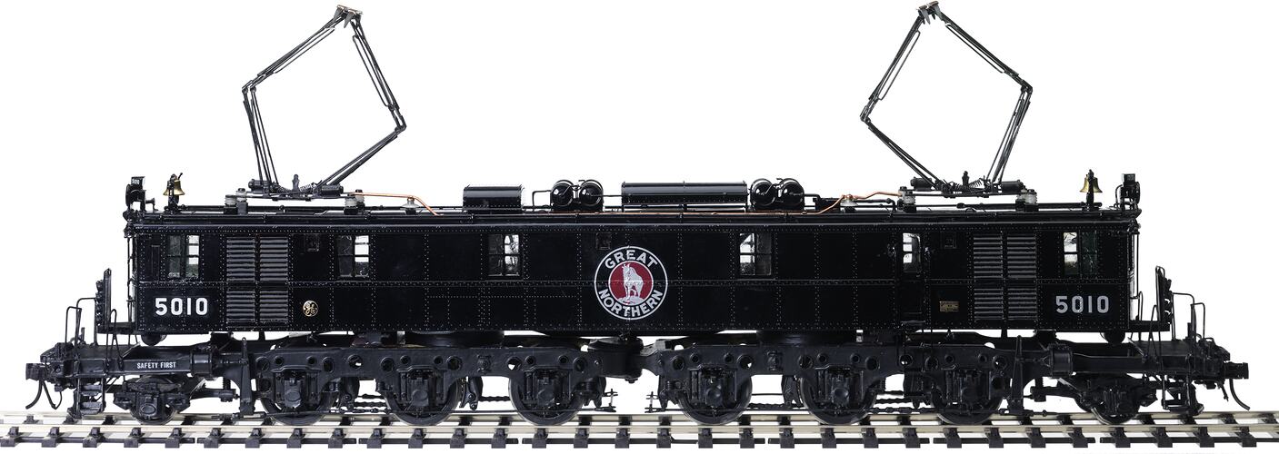 Metal locomotive model painted black with 'Great Northern' logo.
