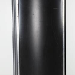 Black cylinder-shaped darkroom door.