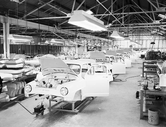 Monochrome photograph of a vehicle manufacturing plant.