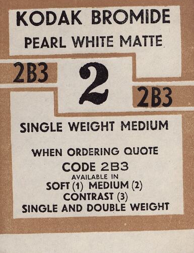 Brown and white paper label with printed text.
