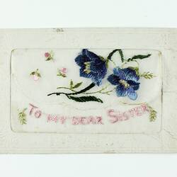 Front of embroidered postcard with flower motif.