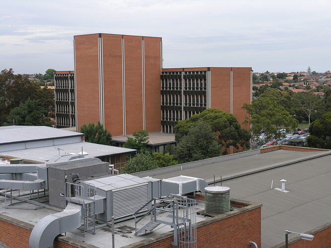 Multistorey brick buildings and corrugated iron rooves.
