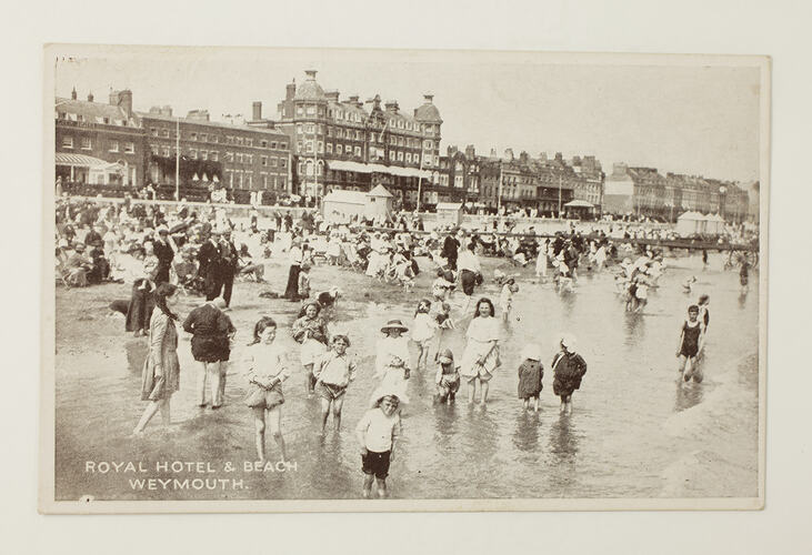 Front of postcard with photo of beach scene.