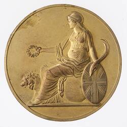 Medal, Britannia sits on globe near lion, holds out laurel wreath. Palm branch in left hand rests on shield.