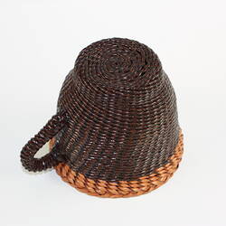 Underside of woven and braided leather tea cup.