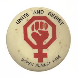 White round badge with central red women's symbol, a clenched fist within. Black text around border.