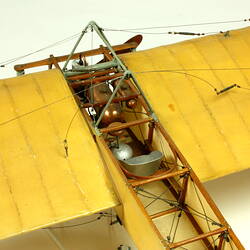 Model aeroplane with exposed wooden frame and off white panelling. Top view.