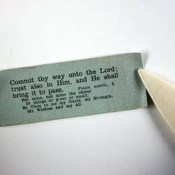 Open scroll containing verse.