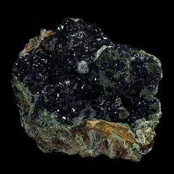 Blue crystals on green-stained rock.