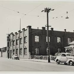 Photograph - Kodak Australasia Pty Ltd, Streetscape View of Factory Building with Parked Car, Burnley, Victoria, circa 1953