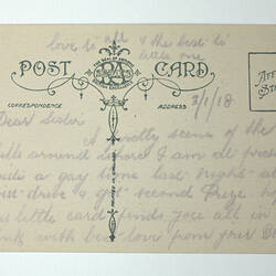 Printed back of postcard with handwriting.