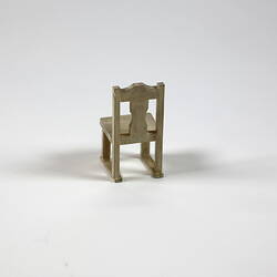Reverse of cream painted wooden chair.