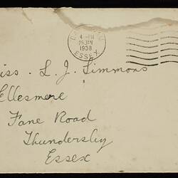Cream envelope with handwritten text in black ink. Black ink stamp and red postage stamp at top right,