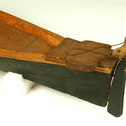 Wooden boat with black hull, rear detail.