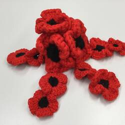 Crocheted woollen poppy flower arrangement.