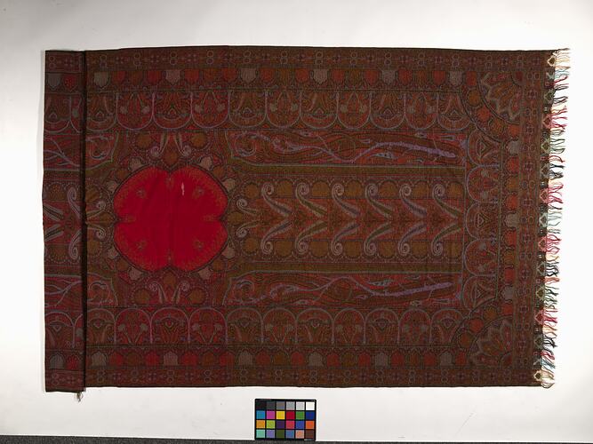 Finely woven red twill tapestry shawl with paisley design in red, orange, black, white and blue.