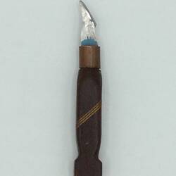 Knife with carved dark wooden handle and small blade. Three diagonal lighter wooden strips in handle centre.