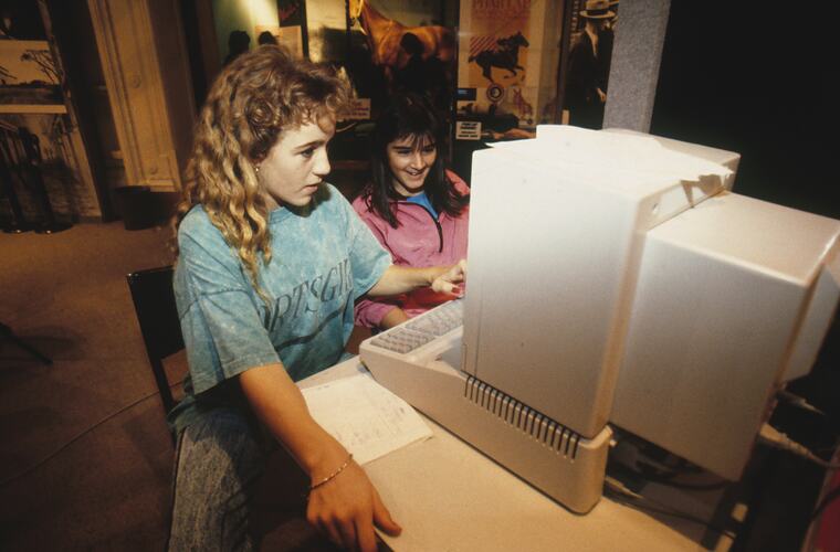 Two female students working with a computer.