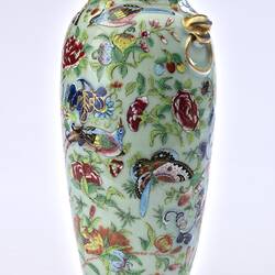 Porcelain vase with all-over pattern of birds, flowers, butterflies and two rats climbing amongst branches.