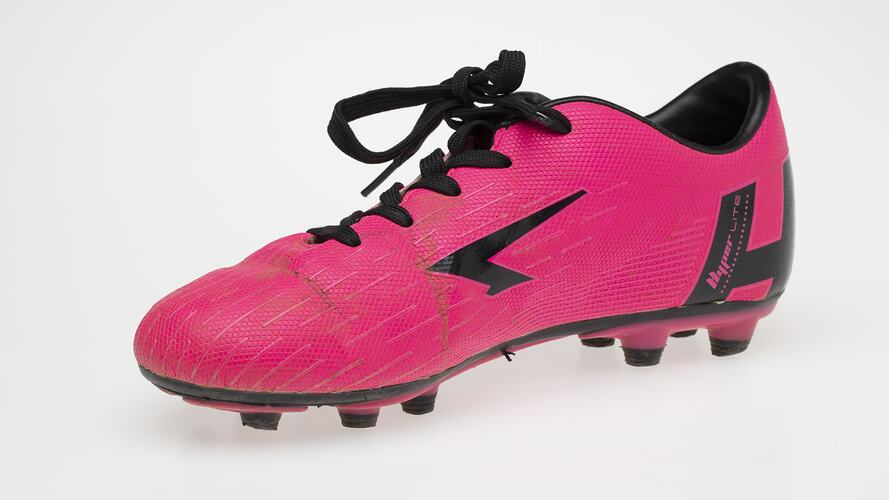 Pink Australian Rules football boot with black bootlace, lining and sole.