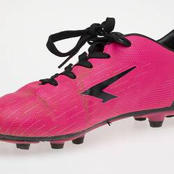 Pink Australian Rules football boot with black bootlace, lining and sole.