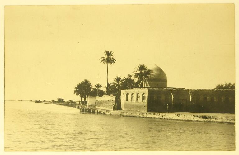Islamic mosque on bank of river.