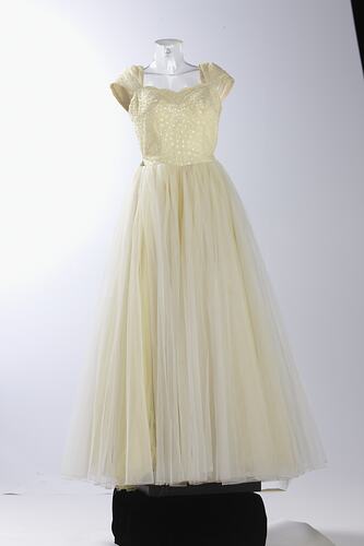 Full length cream evening gown, yellow sequins.