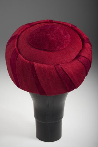Back of beret-style scarlet hat, turban shape.