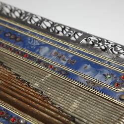 A decorated blue piano accordion with word "Italia" showing.