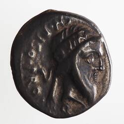 Round coin, aged, male profile, facing right, wearing headdress.
