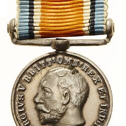 Round silver medal with profile of bearded male, text around.  Blue, black, white, orange striped ribbon.