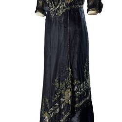 Black beaded and silk satin full length dress with v-neck and three-quarter length sleeves.