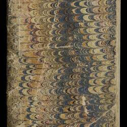 Front cover of worn, discoloured book with marbled patterning.