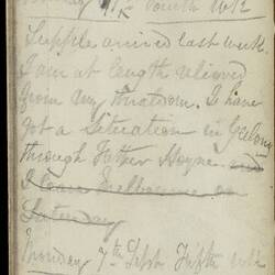Open diary with handwritten text on discoloured worn page.