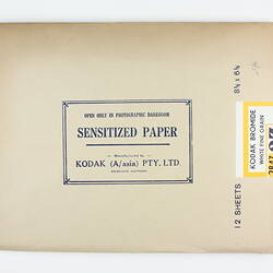 Brown paper packet with yellow product sticker.