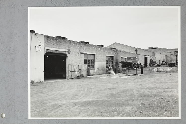 Monochrome photograph of a workshop.