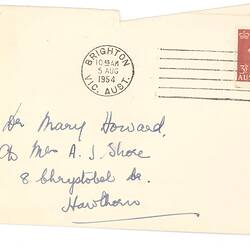Addressed, stamped envelope with handwritten annotations in blue ink in two different hands on front side