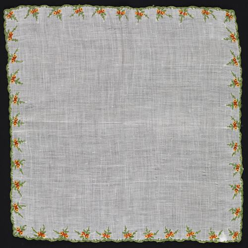 Unfolded handkerchief with embroidered orange and Yellow Flowers.