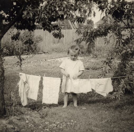 Susan Leech Playing Hanging Out Washing in Back Yard, Frankston, circa 1954