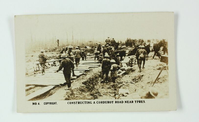 Soldiers building a road of wood planks.