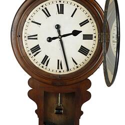 Open wall clock with cedar drop dial case. White clock face with black Roman numerals. Dial case lid off.