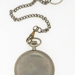 Back of closed silver metal round fob watch with metal cover and chain.
