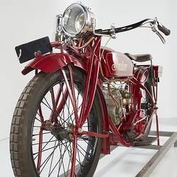 Red motor cycle, left front view.