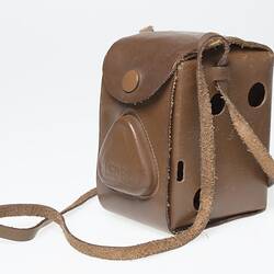 Tan leather camera carry case with strap.