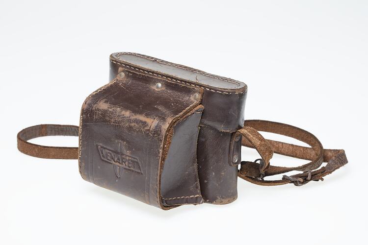 Dark tan leather camera carry case with strap.