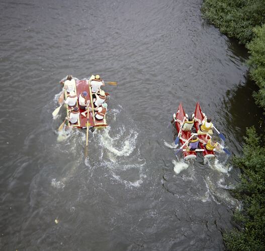 Aerial view of people on rafts in river.