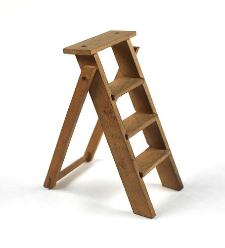 Toy wooden ladder, upright facing right.